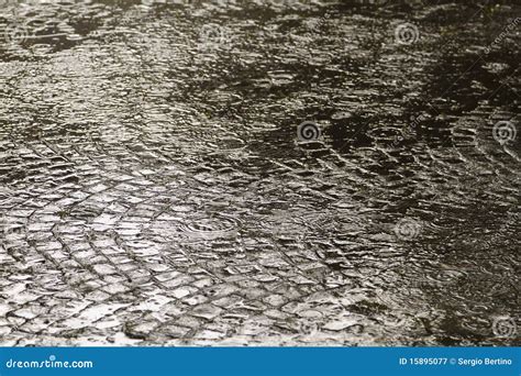 Rain on sett paving stock image. Image of pedestrian - 15895077