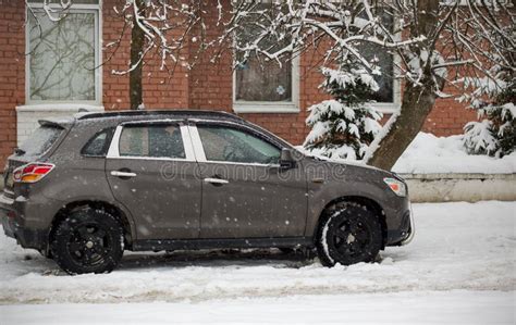 A Brown Car Is Parked Outside The House Stock Photo Image Of