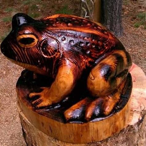 A Carved Turtle Sitting On Top Of A Tree Stump