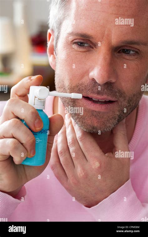 MAN USING MOUTH SPRAY Stock Photo Alamy