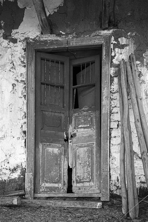 Old Damaged Wooden Door In An Old Wall Made Of Mud And Straw Mixture