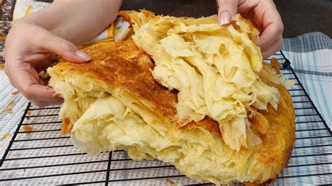 A Person Is Holding Up Some Food On A Rack