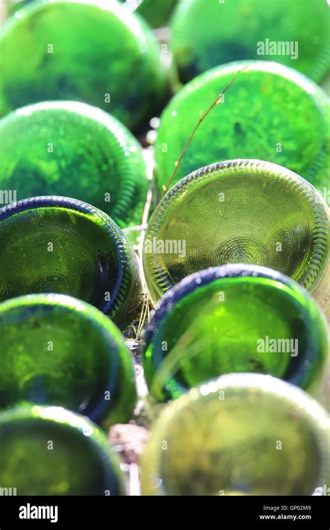 Rows Of Green Glass Bottle Bottoms In Sand From Which It Originated Showing Cycle Of Life And