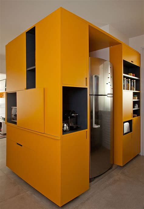 A Kitchen With Yellow Walls And Cabinets In It S Center Area As Well