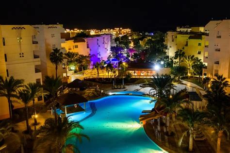 Premium Photo | View on a swimming pool in hotel resort at night