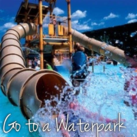 People Are Playing In The Water At An Amusement Park