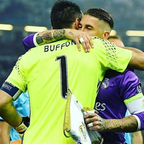 Two Soccer Players Hugging Each Other On The Field