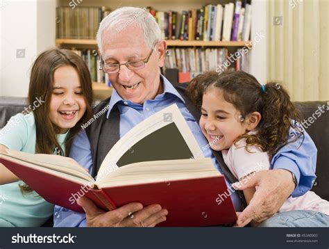 Grandfather And Grandchildren Reading A Book Stock Photo 45340903