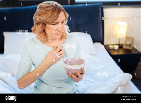 Pretty Light Haired Mature Woman Carrying Bowl With Porridge Stock Photo Alamy