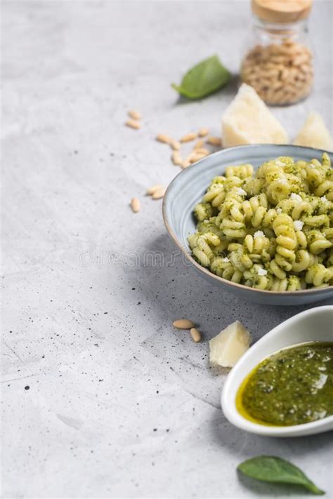 Plate Of Pasta Fusilli With Pesto Sauce And Parmesan Cheese On Gray