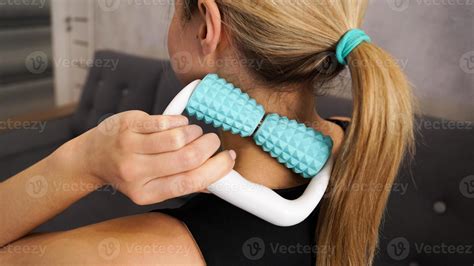 Woman massaging herself with body roller. Neck massage. Prevention of ...