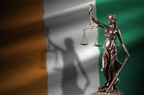 Premium Photo Ivory Coast Flag With Statue Of Lady Justice And