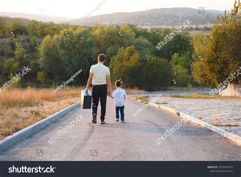 Father Son Walking Away On Road Stock Photo 1953097507 Shutterstock