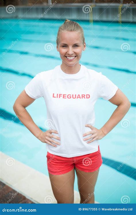 Confident Female Lifeguard Standing At Poolside Stock Image Image Of