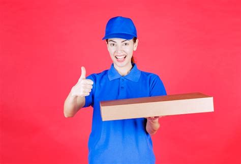 Premium Photo Female Courier In Blue Uniform Holding A Cardboard