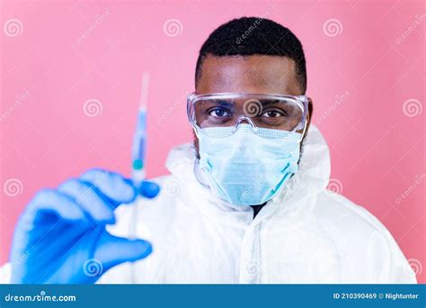 African American Man Scientist In Ppe Suite Uniform Showing Medicine