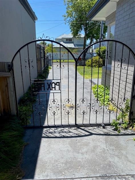 Wrought Iron Driveway Gate With Decorative Iron And Name Paxhill