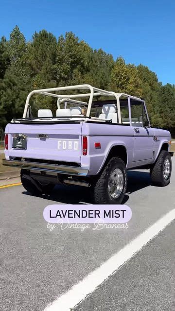 A Purple Truck Parked On The Side Of A Road With Trees In The Back Ground