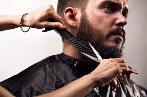 Premium Photo A Man Getting His Hair Cut By A Barber