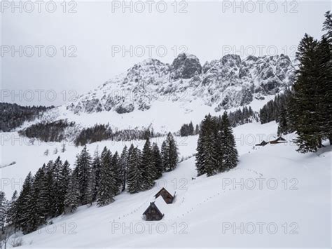 Winter Landscape With Alpine Huts In Front Of Snow Covered Bosruck