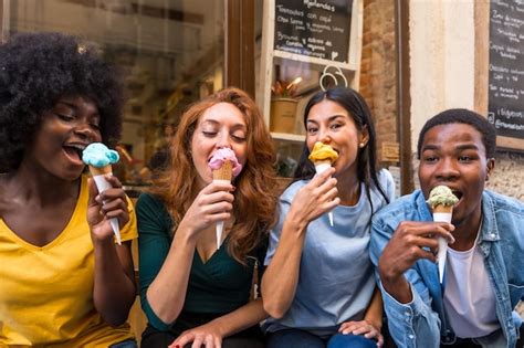 Premium Photo | Multiethnic friends in an ice cream parlor eating ice cream summer fun sucking ...