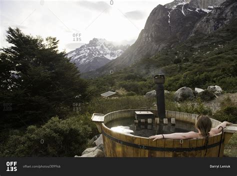 Woman Resting In A Hot Tub Overlooking A Mountain View Stock Photo OFFSET