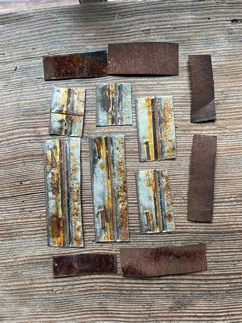 twelve rusty  shiny metal pieces cut rusted metal metal art