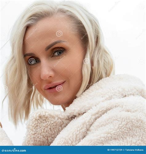 Beautiful Blonde Woman In Eco Fur 35 Years Old Looking At The Camera