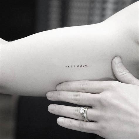 Minimalist Date Tattoo In Roman Numerals On The Right