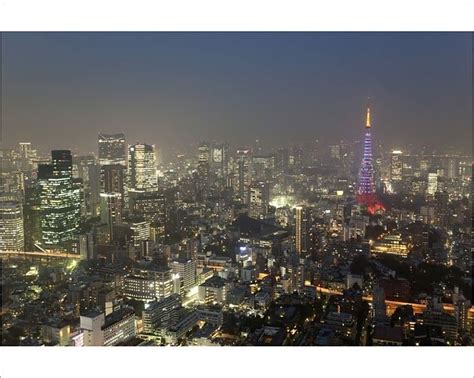 an aerial view of the city at night with skyscrapers lit up in bright ...