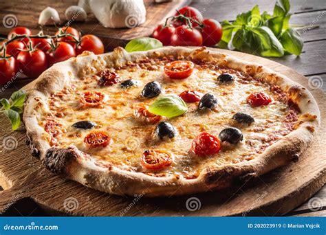 Homemade Pizza With Tomatoes Mozzarella Cheese Olives And Basil Stock