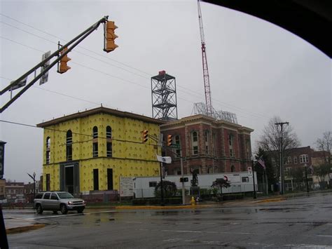 A Yellow Building Under Construction In The Middle Of An Intersection