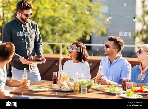 Friends At Bbq Party On Rooftop In Summer Stock Photo Alamy