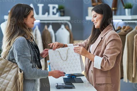 Woman Seller And Buyer In Clothes Store Stock Photo At Vecteezy