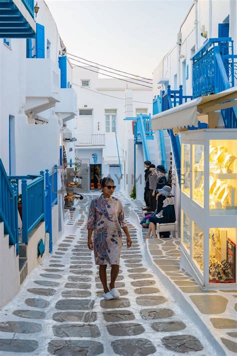 Tourist At The Streets Of Mykonos Greek Village In Greece Colorful