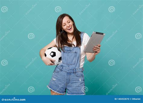 Joyful Young Woman Football Fan Holding Soccer Ball Using Tablet Pc