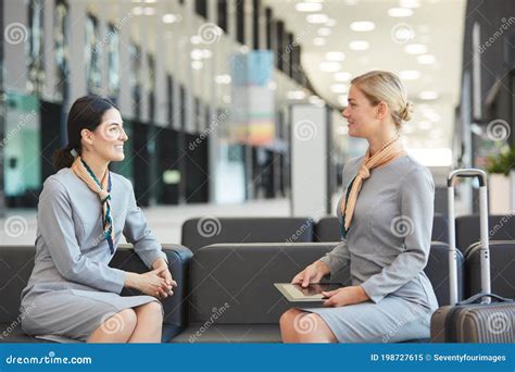 Two Flight Attendants Chatting In Waiting Lounge Stock Image Image Of