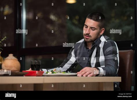 Handsome Man Eating At A Restaurant And Looking Happy Stock Photo Alamy