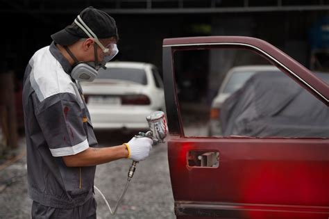 Free Photo Man Spraying Powder Paint On Car Door Side View