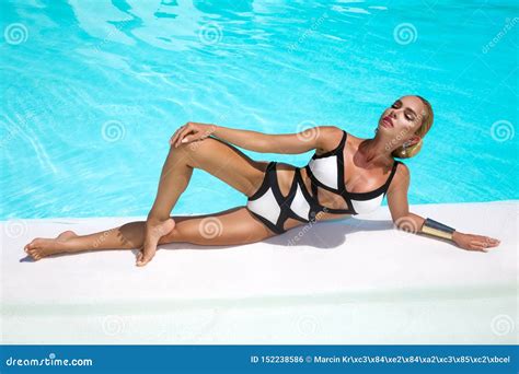 Elegant Woman In Luxury Bikini On The Sun Tanned Slim And Shapely Body