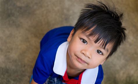 Asian Boy Looking Up Smiling To The Camera Stock Photo Download Image