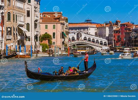 VENICE, ITALY - AUGUST 22, 2016: Tourists Ride in Gondola Near Rialto ...