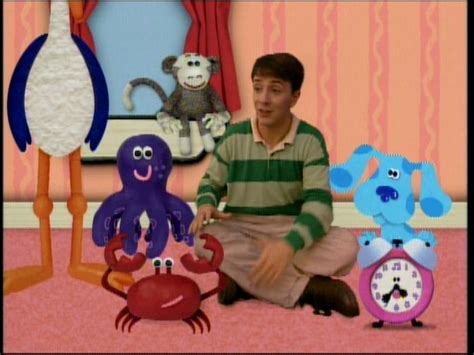 A Young Man Sitting On The Floor Next To Some Toys And An Octopus In Front Of Him