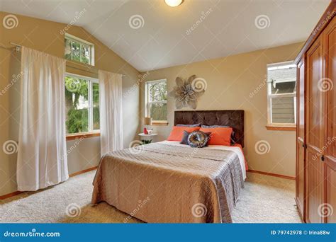 Upstairs Bedroom with Vaulted Ceiling and Beige Walls Stock Photo ...