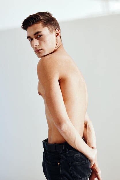 Premium Photo Sexy Man In Dark Trousers On A Light Background Naked Torso