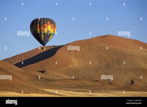 Hot Air Balloon Flying Past Sand Dunes Near Sossusvlei In The Namib Naukluft National Park