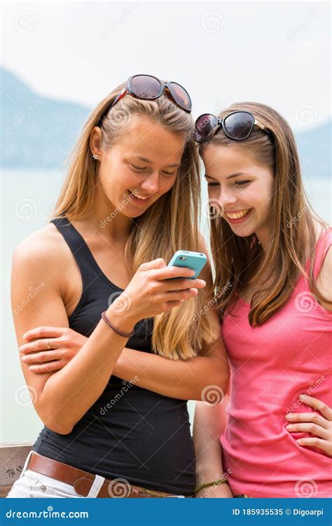 Two Pretty Young Girls Looking At Mobile Phone Stock Image Image Of