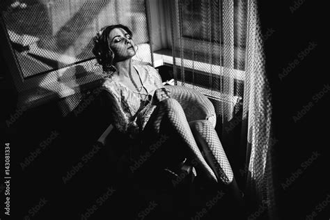 Beautiful Woman In Lingerie Showing Long Legs Sexy Pose Leaning At Bed Over Her Bedroom With Big