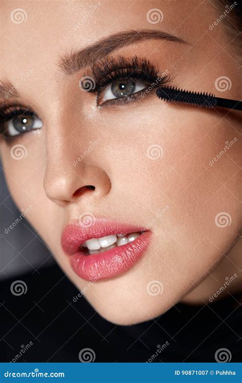 Cosmetics Beautiful Woman With Perfect Makeup Applying Mascara Stock