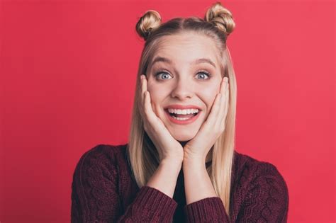 Premium Photo Blonde Woman With Top Knots Posing Against The Red Wall